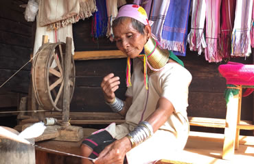 Long neck Kayan woman weaving using a traditional backstrap loom